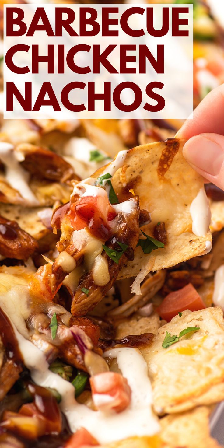 a hand holding a tortilla chip with chicken nachos on it and the words barbecue chicken nachos above it