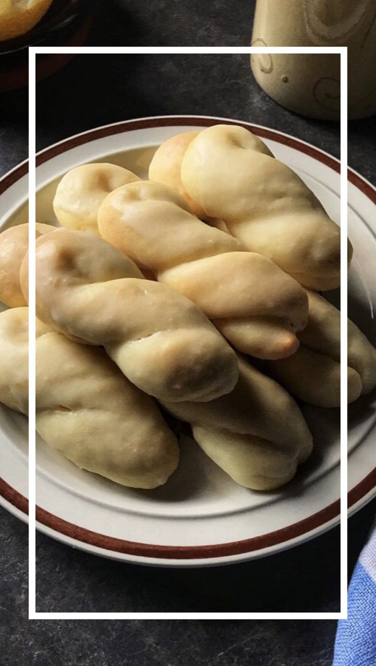 bread rolls on a plate with a white rectangle in front of it and an orange stripe around the edges