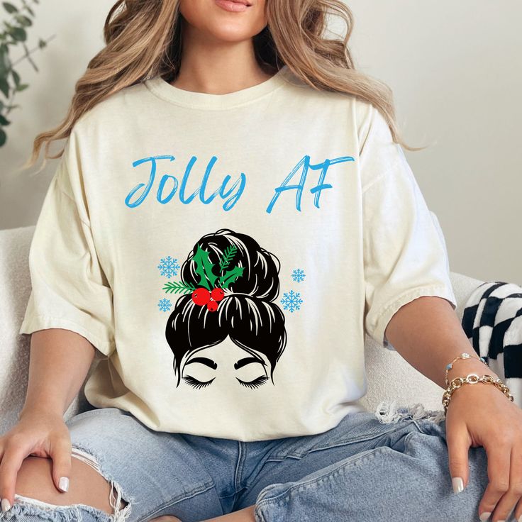 a woman sitting on top of a couch wearing a white shirt with the words jolly af printed on it