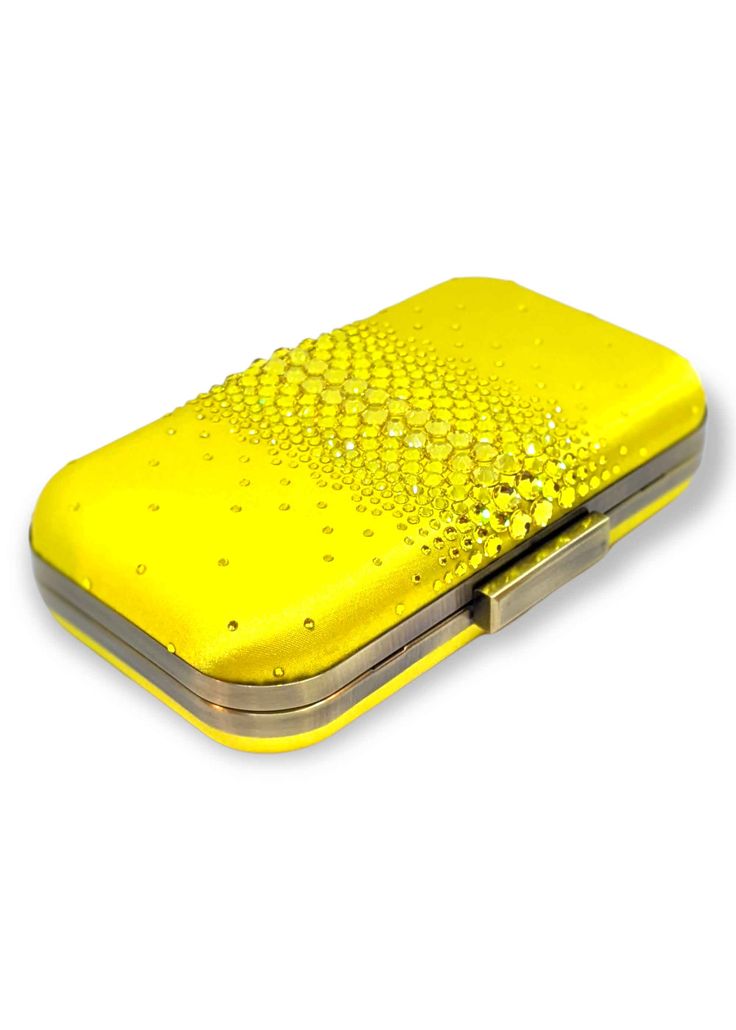 Add a pop of color with this glamorous yellow satin clutch — ELLA is adorned with the highest quality brilliant cut crystals to add the perfect touch of sparkle to any look. Perfect for pairing with a vibrant evening gown to bring out its designs, the Ella Crystal Clutch is a beautiful evening wear clutch with just enough detail to make the accents of your dress shine. Against a smooth and soft satin background layer are clear, sparkly crystals that are heavy in concentration and large in the ce Elegant Yellow Clutch For Formal Occasions, Elegant Yellow Evening Bag For Formal Occasions, Yellow Rectangular Evening Bag For Party, Yellow Elegant Clutch For Formal Occasions, Chic Yellow Clutch For Formal Occasions, Yellow Clutch Evening Bag For Party, Elegant Yellow Evening Bag, Chic Yellow Clutch For Party, Yellow Luxury Clutch Evening Bag For Party