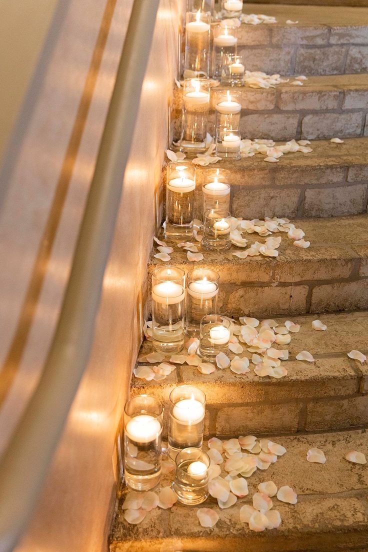 many candles are lit on the steps outside