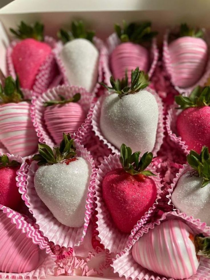 a box filled with pink and white chocolate covered strawberries