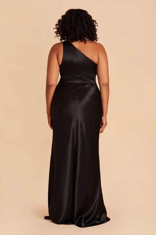 a woman in a black one shoulder dress