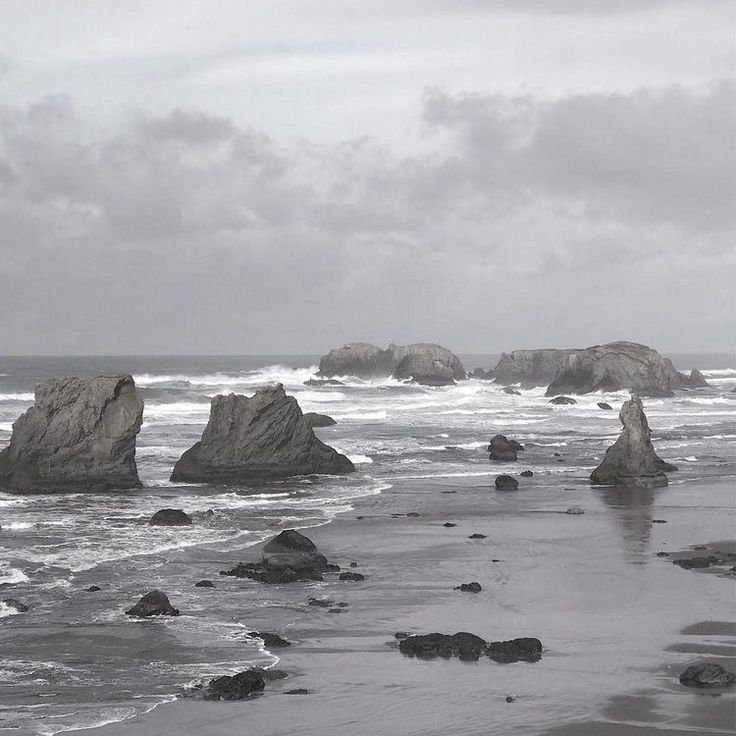 some rocks in the water on a cloudy day