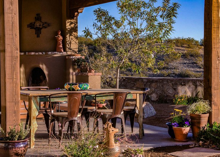 an outdoor dining area with patio furniture and potted plants