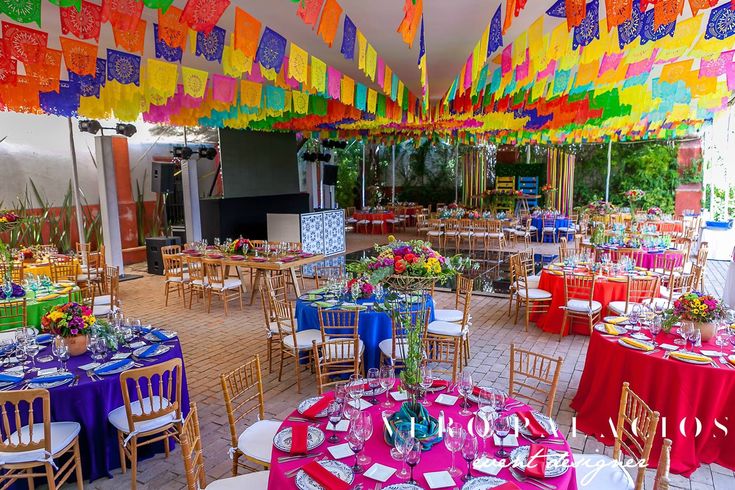 a room filled with lots of tables covered in colorful paper