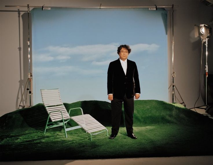 a man standing next to a lawn chair