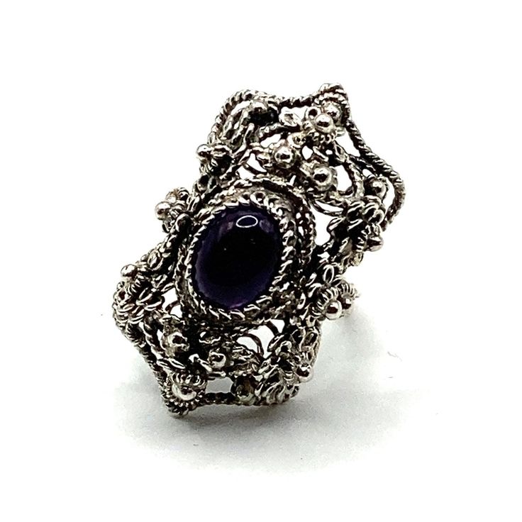 This ring is one of our new vintage collection items I discovered recently from another part of my family. The ring is a handmade filigree work from one of our family master jewelers and was revived in order to present this exceptional art. It was reconditioned and updated with a new Amethyst stone. The entire ring is hand made with filigree techniques used by my families filigree masters. The material used is sterling silver (925). This ring symbolizes the night on Adriatic beaches. Size: 5.5 L Vintage Purple Sapphire Gemstone Ring, Purple Anniversary Rings With Intricate Design, Purple Oval Filigree Rings, Vintage Crystal Gemstone Open Ring, Heirloom Amethyst Rings With Intricate Design, Heirloom Style Open Ring With Intricate Design, Vintage Open Crystal Gemstone Ring, Handmade Vintage Filigree Ring, Purple Oval Ring With Intricate Design