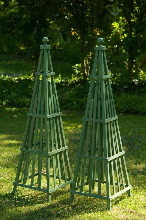 two green wooden stands in the grass