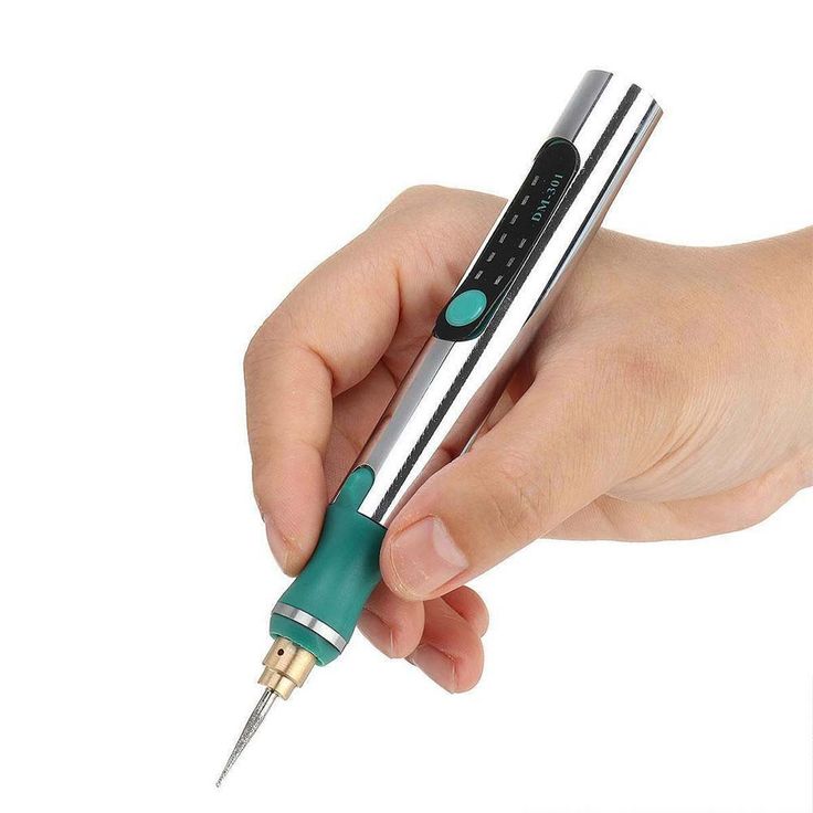 a person is holding a pen in their hand