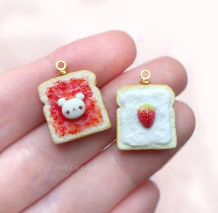 two pieces of bread with strawberry jam on them and a teddy bear in the middle