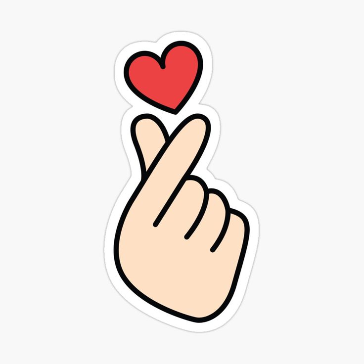 a hand holding a red heart sticker