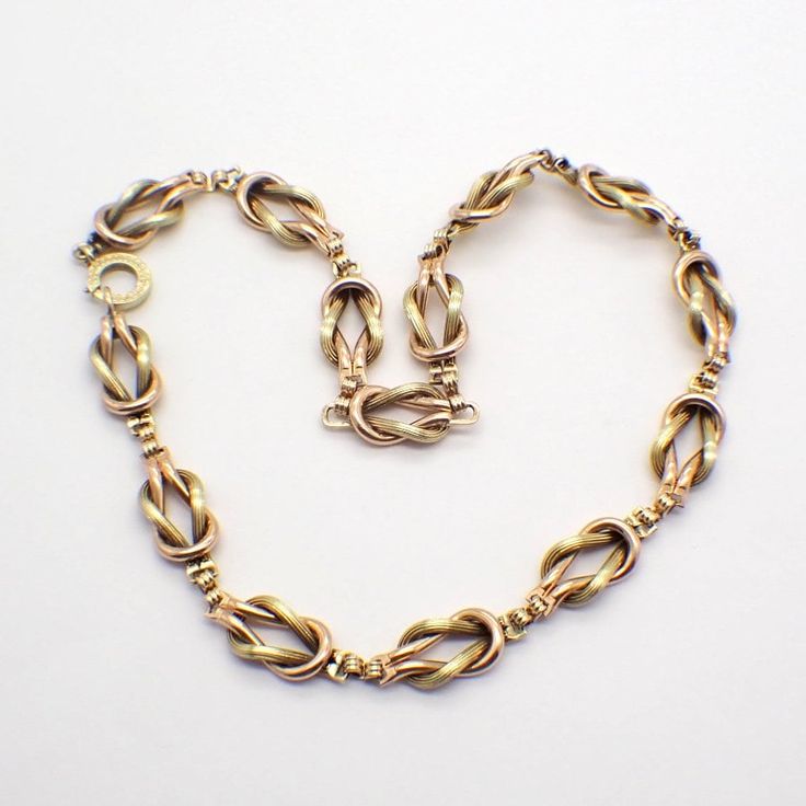 American designer Walter Lampl vintage two-tone 14k (.585) gold chain necklace, made of figural Love Knot motif links. This incredible necklace is 16 1/4" long, 10.6 mm wide, weighing 62.7 grams or 2.02 ozs Troy. EA5387 Yellow Gold Necklaces With Hook And Links For Gift, Yellow Gold Link Necklace, 14k Gold Link Necklace With Hallmark, Vintage Gold Necklace With Hook And Links, Victorian Gold Necklace With Figaro Chain, Vintage Gold Necklace With Hooks And Links, Vintage 14k Gold Chain Necklace, Victorian Gold Link Necklace, Vintage Yellow Gold Link Necklace