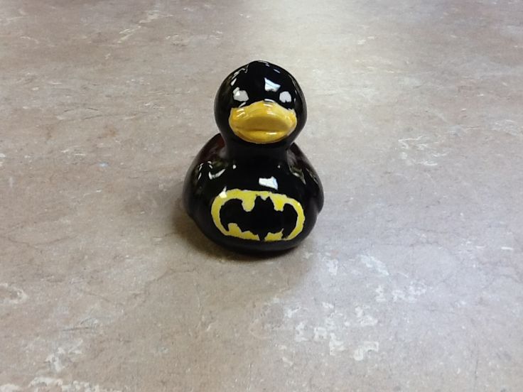 a batman rubber duck sitting on the floor