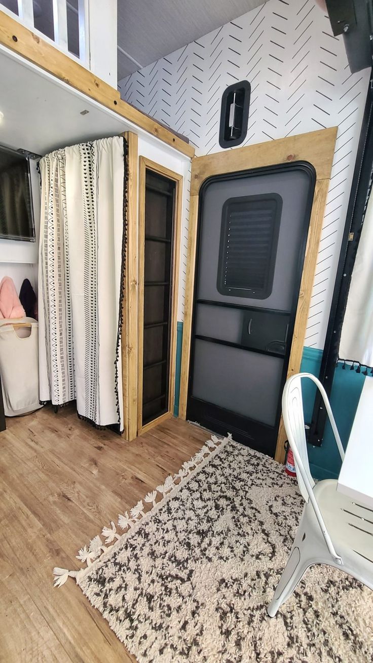 the interior of an rv that has been converted into a living area with sliding doors