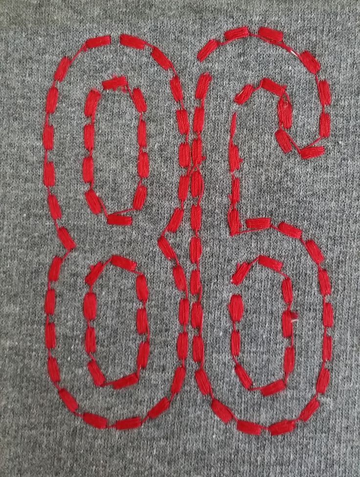 the number six is drawn in red on a gray shirt