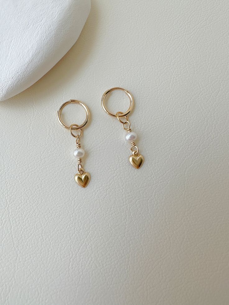 "These cute freshwater pearl and mini heart earrings are handmade from 14k gold filled, the pearl and heart charms can be removable. -------------------------------------------------------- >>  Material: 14k gold filled  hoop and tiny heart  >> Length: 3cm >>  Hoop Diameter: 10mm >>  Pearl Diameter: 3-3.5mm >>  Sensitive skin friendly & tarnish resistant ------------------What is gold filled ------------------ Most of our findings and wires are made with 14k gold filled.\"Gold-filled\" is a USA industry standard that legally requires 5% pure gold by weight. It is a solid layer of gold bonded to another metal through heat and pressure. It does not wear off or turn colours over time, and if taken care of properly it can last a lifetime.Gold-filled jewellery is a cheaper, yet the best alterna Cute Charm Earrings, Danty Earrings, Gold And Pearl Earrings, Pearl Heart Earrings, Cute Jewellery, Handmade Pearl Jewelry, Small Pearl Earrings, Pretty Jewelry Necklaces, Hoop Charms