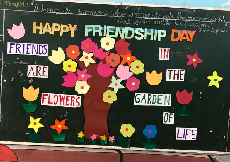 a sign with flowers and words on it that says happy friends day in the garden of life