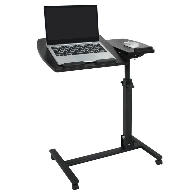 a laptop computer sitting on top of a black stand next to a white keyboard and mouse