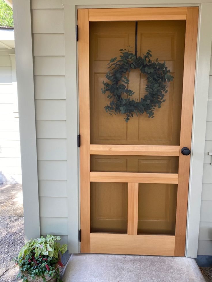 a wooden door with a wreath on it