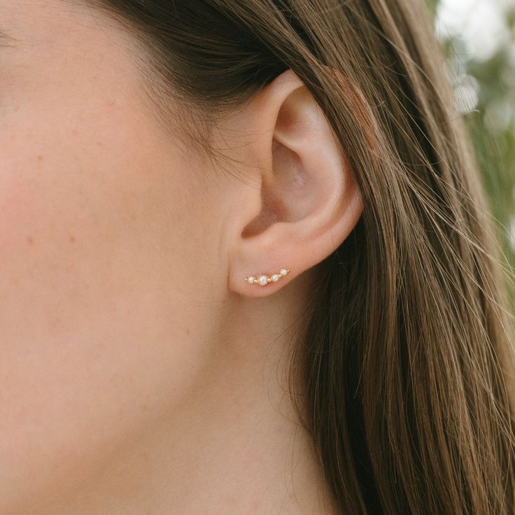 Add a sweet touch to your ear stack with our Pearl Climber Stud Earrings. Choose from gold or silver to effortlessly achieve a delicate look, perfect for everyday wear. Layer them with our Pearl Huggies for a stylish and versatile option. DETAILS stud back measures 12mm long available in gold or silver sterling silver or 14kt gold plated over sterling silver nickel free synthetic pearls Dainty Sterling Silver Ear Climbers, Dainty Gold Cubic Zirconia Ear Climbers, Minimalist Gold Sterling Silver Ear Climbers, Dainty Gold-plated Single Ear Climber, Pearl Huggies, Personalized Gold Jewelry, 14k Gold-filled Pearl White Earrings With Pearl Charm, Pearl Necklace Earrings, Ear Stack