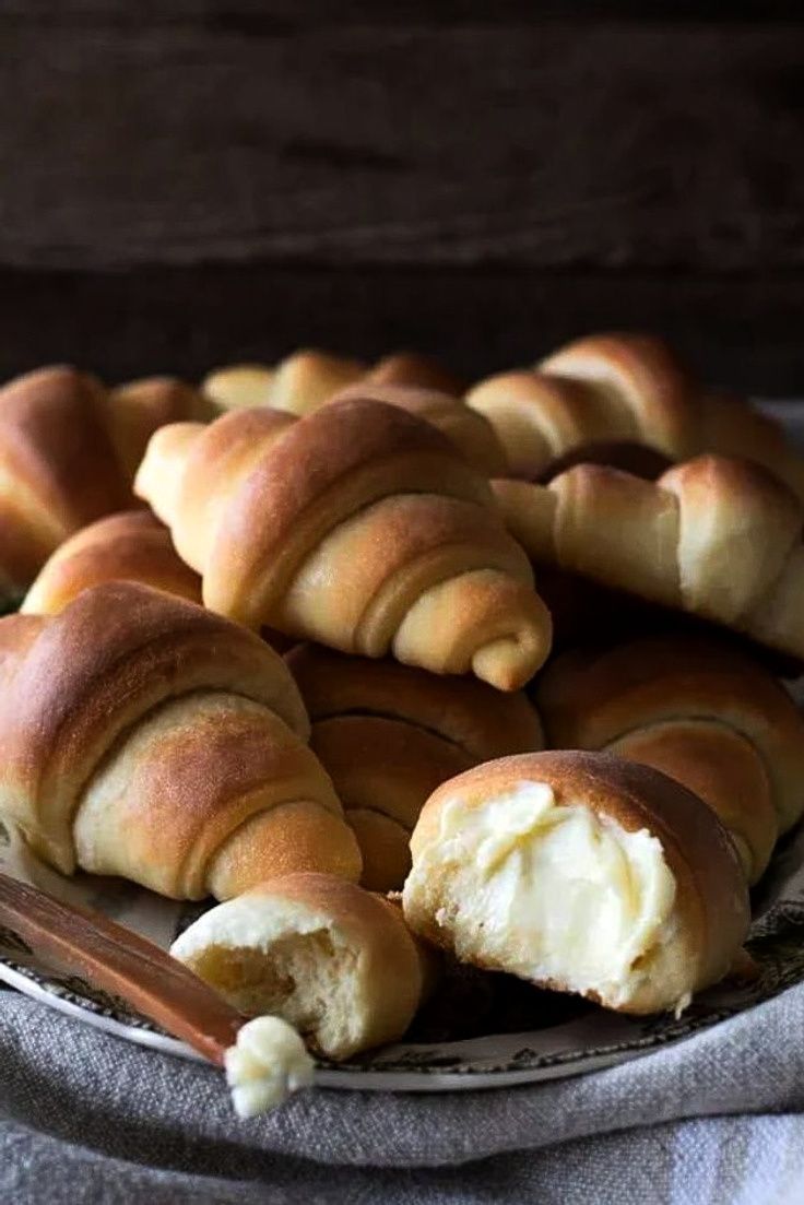 several pieces of bread on a plate with butter and cinnamon sticks next to it,