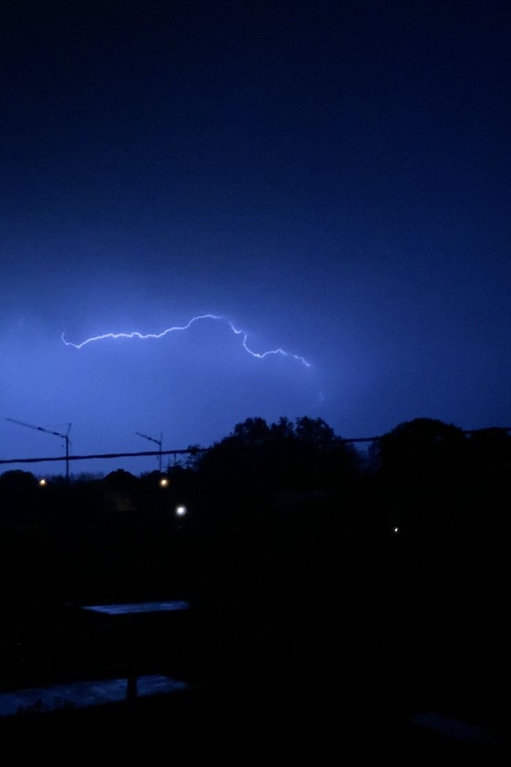 a lightning bolt is seen in the night sky