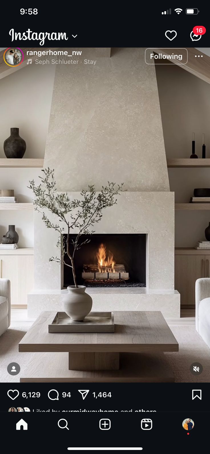 a living room filled with furniture and a fire place next to a wall mounted flat screen tv