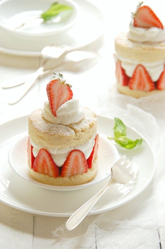 there is a small cake with strawberries on top