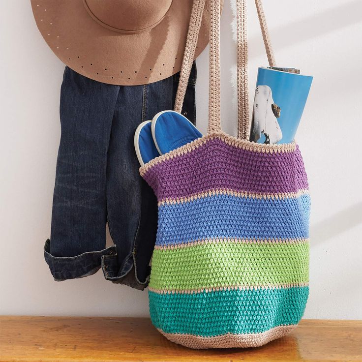 there is a purse and hat hanging on the wall next to a pair of jeans