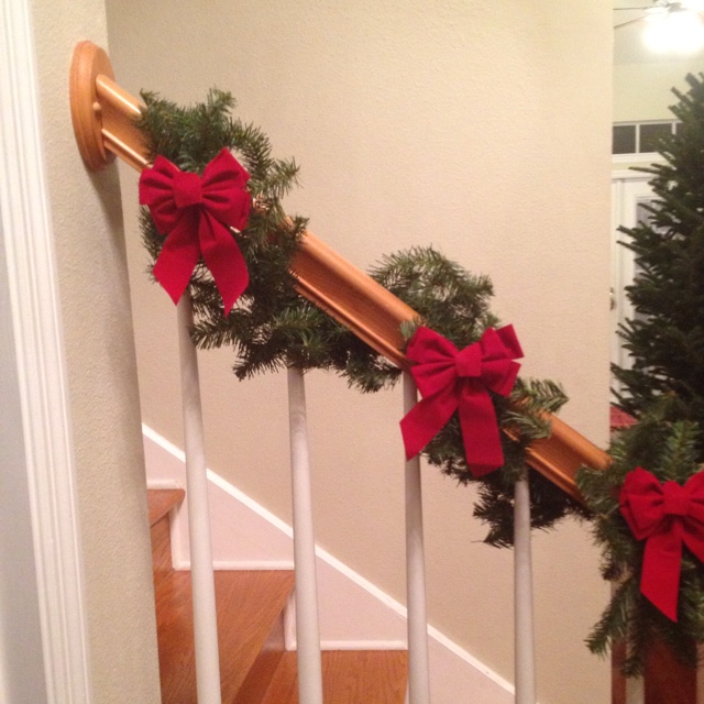 christmas garland on the banisters with red bows