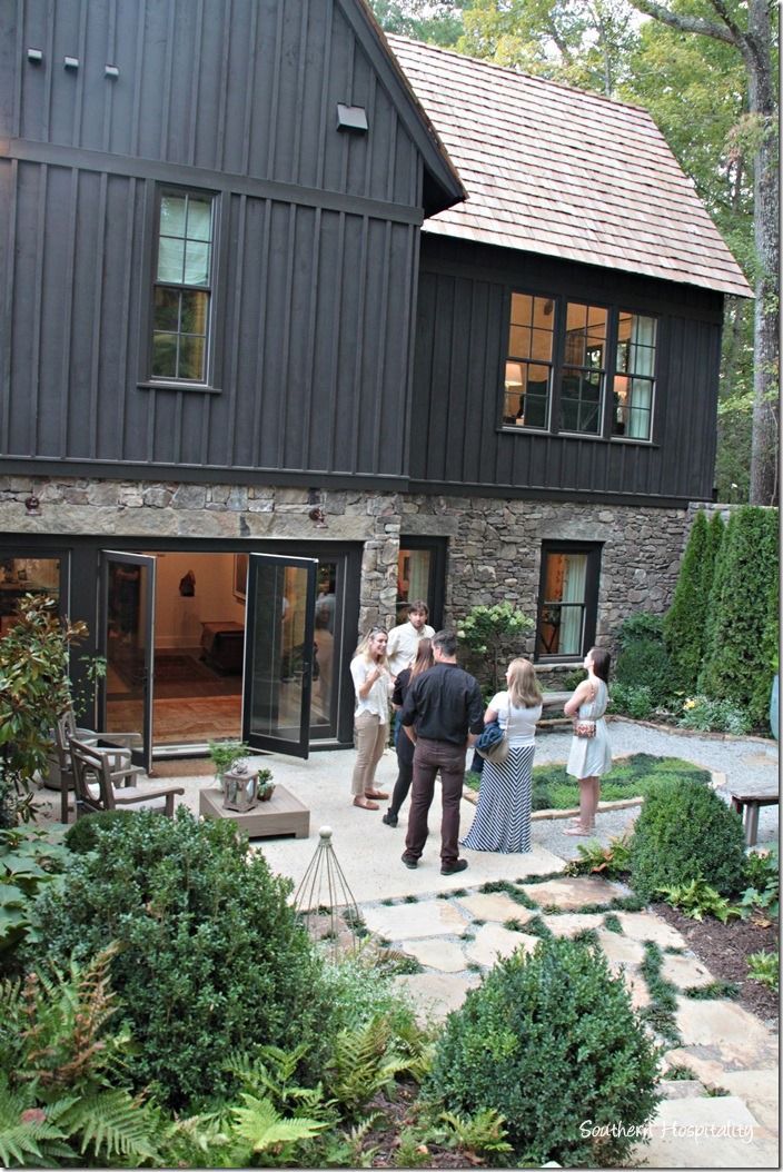 a group of people standing in front of a house