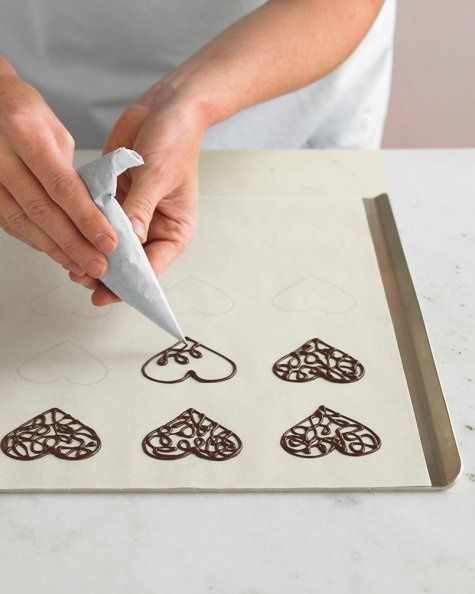 a person using a knife to cut out designs on a piece of paper