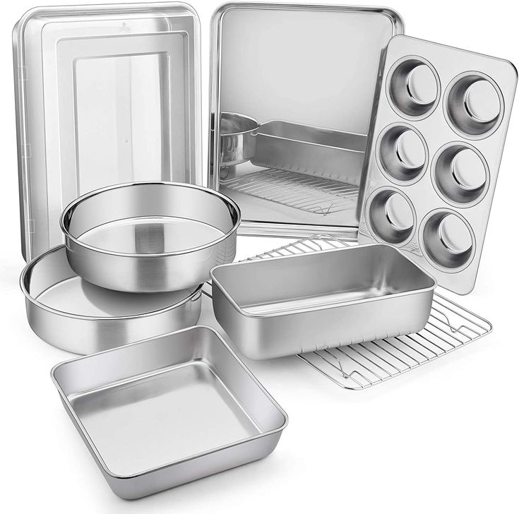 an assortment of metal pans and trays on a white background with clipping for text