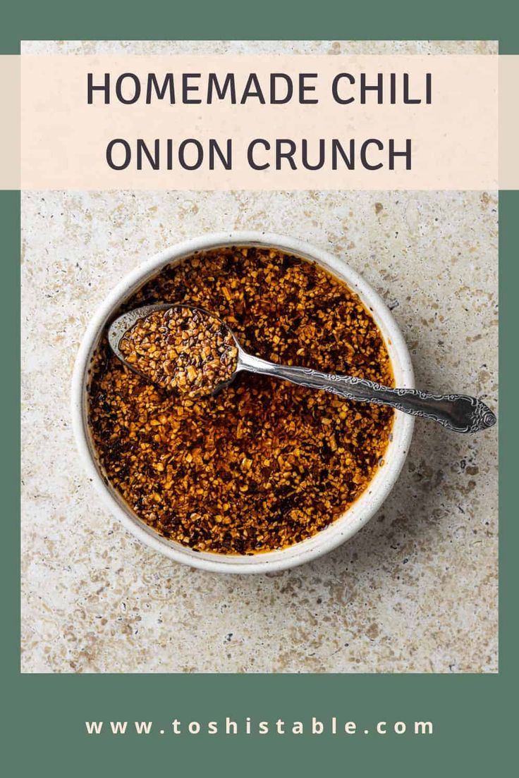 homemade chili onion crunch in a white bowl with a spoon on the side and text overlay