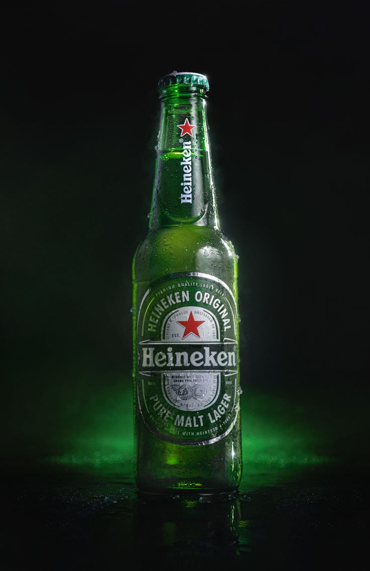 a bottle of heineken beer on a dark background