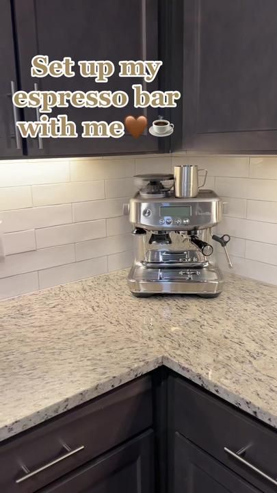 an espresso machine sitting on top of a kitchen counter with the words set up my espresso bar with me