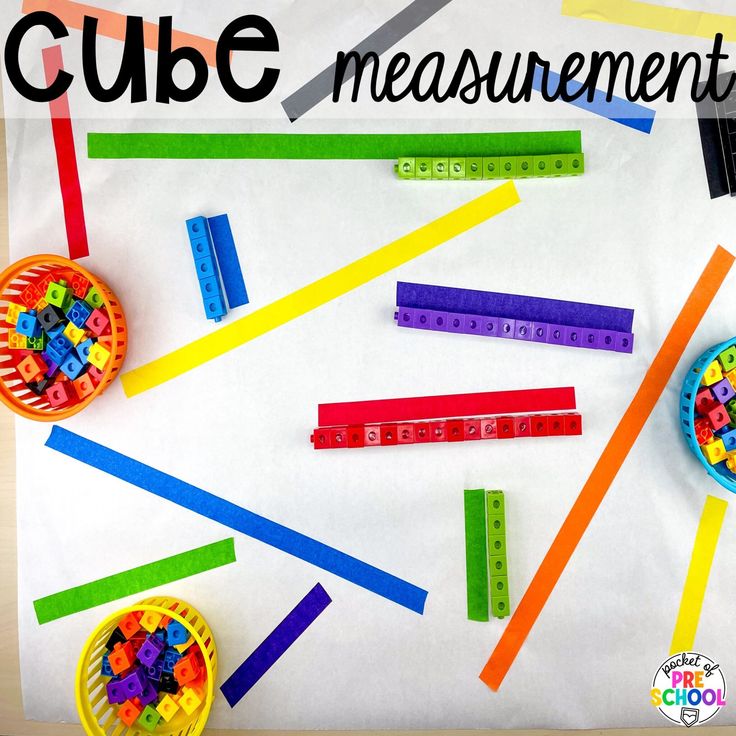 some legos and measuring tape on a table with the words cube measurement in front of them