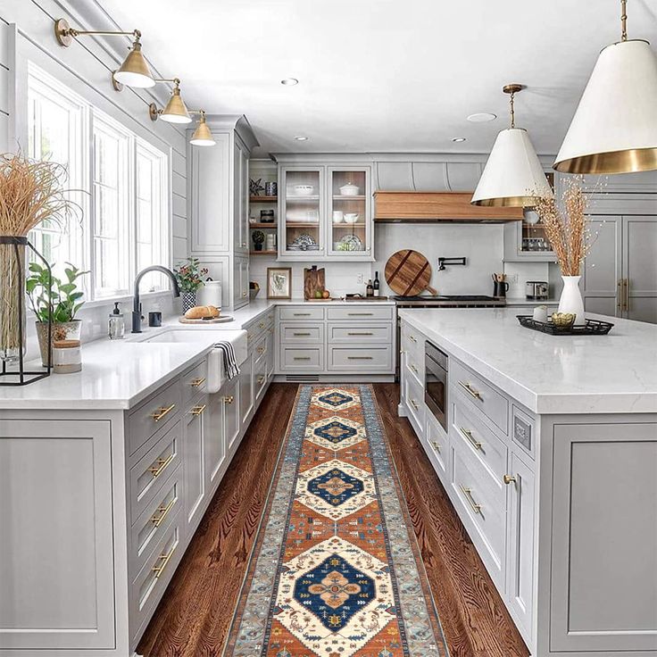 a kitchen with an area rug in the middle of the floor and cabinets on both sides