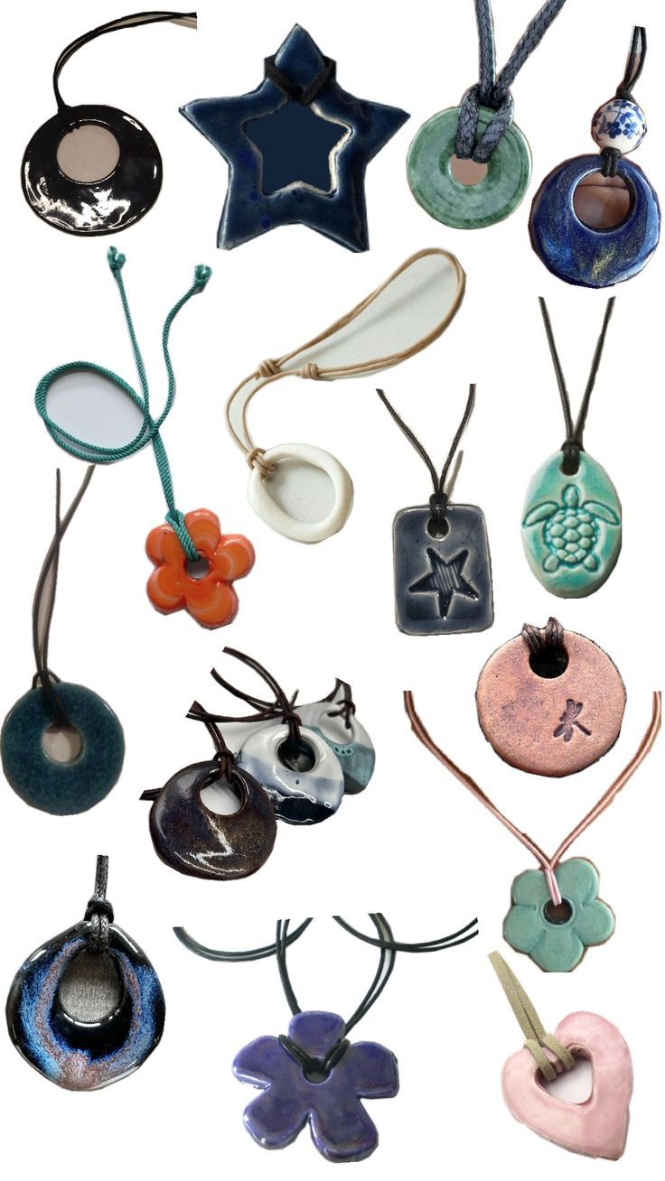 many different types of necklaces hanging from strings