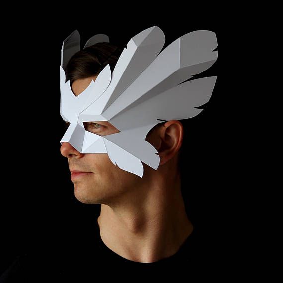 a man wearing a paper mask with wings on his face