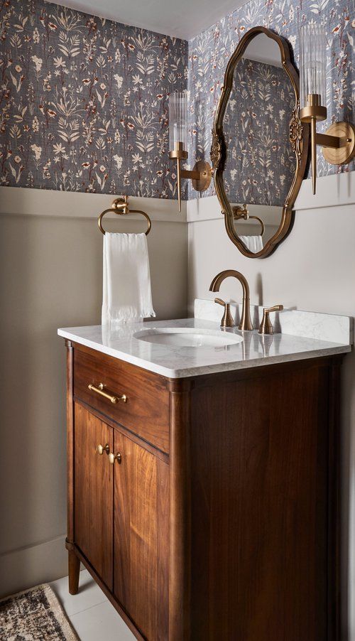 a bathroom with a sink, mirror and rug