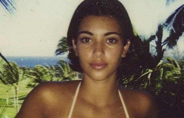 an old photo of a woman in a bathing suit with palm trees in the background