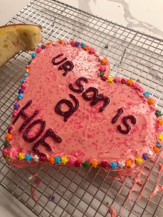 a heart shaped cake on a cooling rack