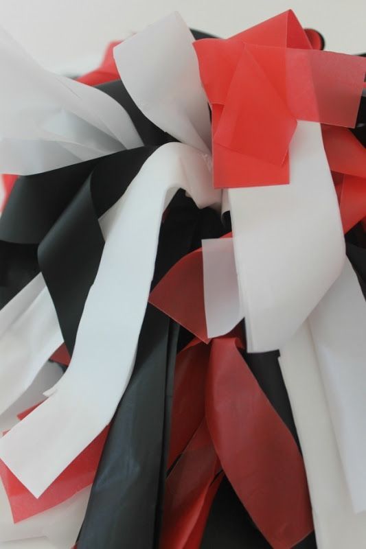 red, white and black streamers are scattered on top of each other in this image