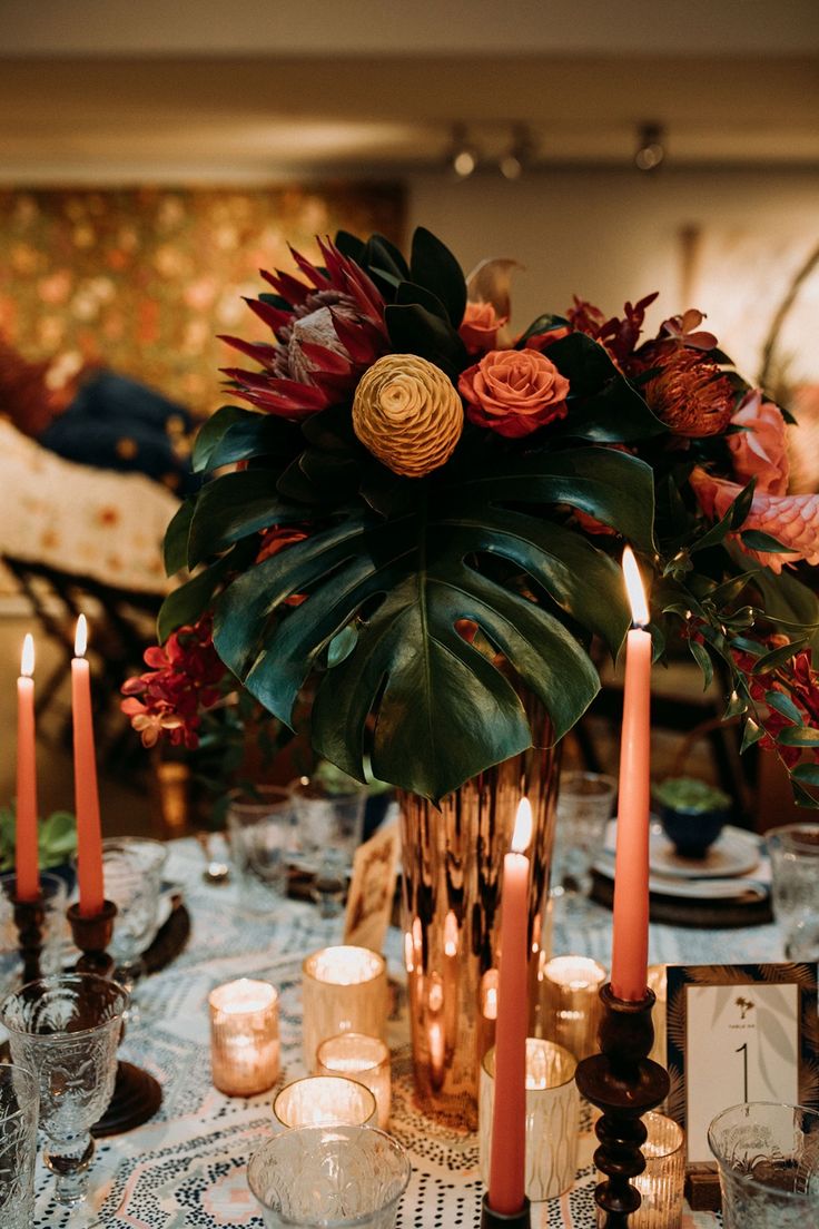 a table with candles and flowers on it