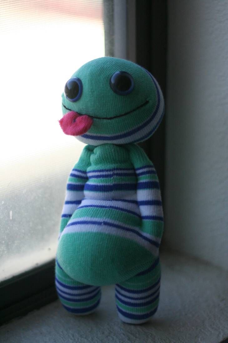 a stuffed animal sitting on top of a window sill