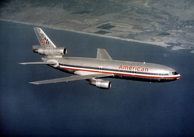 an american airlines jet flying over the ocean