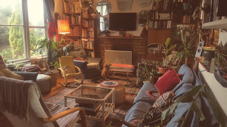 a living room filled with furniture and lots of windows