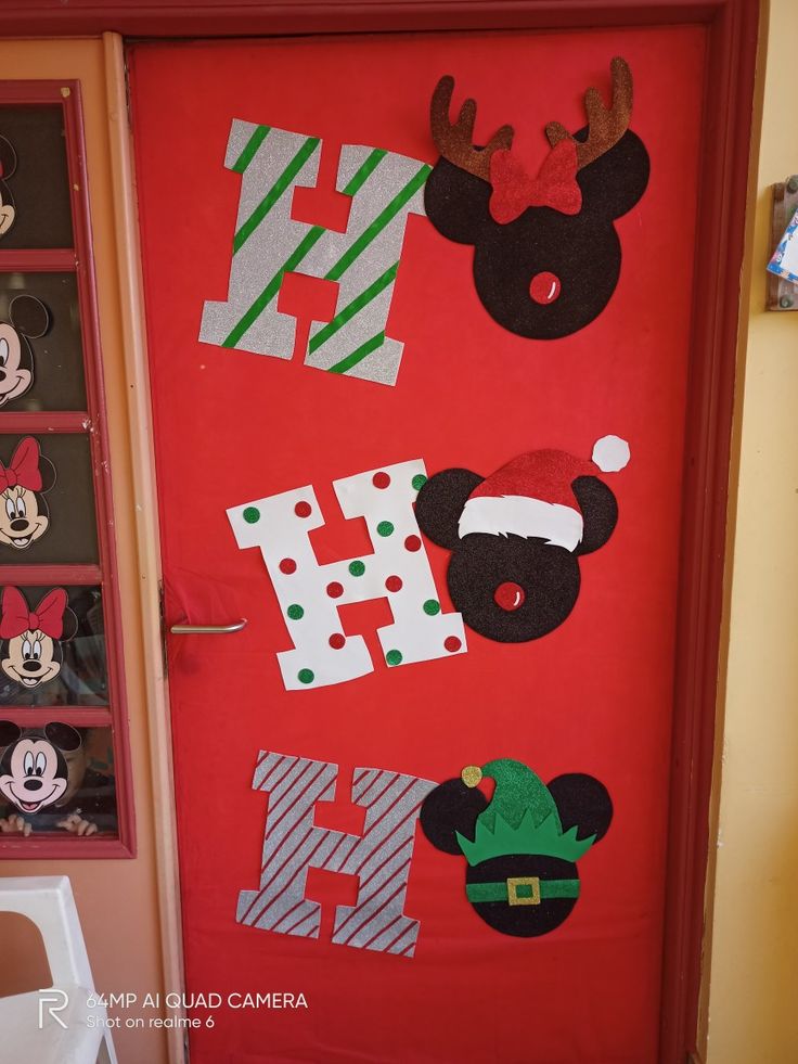 a door decorated with mickey mouses and other holiday decorations, including santa's helper hats